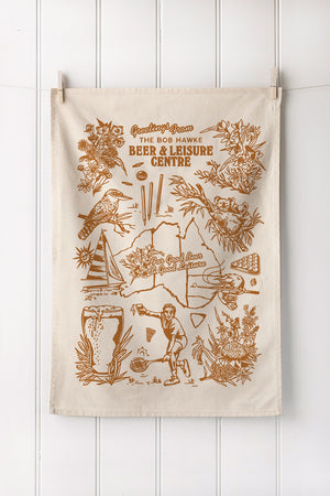 Custom screen printed natural cotton tea towel with earthy botanical artwork in portrait layout – ideal for merchandise or gifts.