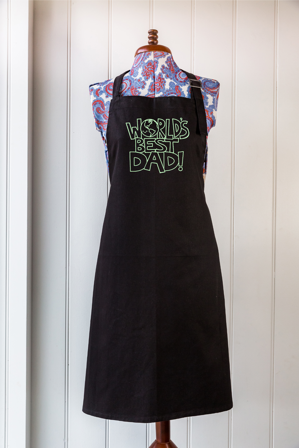Black organic cotton apron with custom green "World Best Dad" screen print