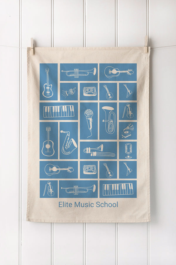 Tea towel with musical instrument illustrations and customer brand text on a white background