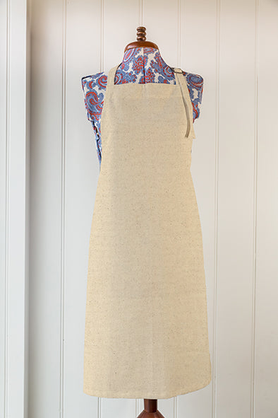 Natural cotton apron plain with no print, hung for display