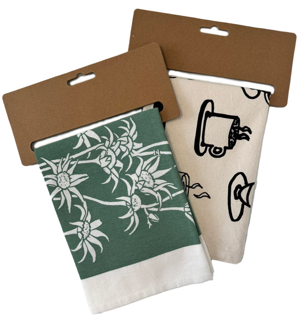 Set of tea towels with kraft hangers featuring botanical and illustrated prints