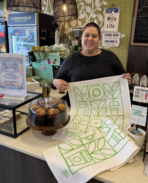 Custom printed organic cotton tea towels displayed in an Australian café setting