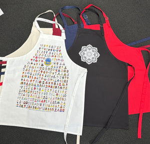 Custom printed aprons in various colours and designs laid flat.