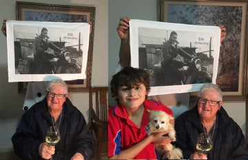 Eric smiling with his great-grandson holding a personalised organic cotton tea towel.