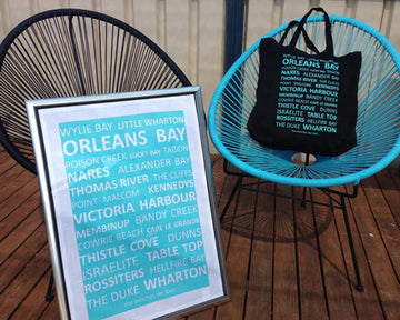 Custom printed aqua tea towel and tote bag featuring Esperance beaches, photographed on a rustic wooden bench.