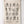 Natural tea towel with black native floral design hanging on a white wooden panel wall.