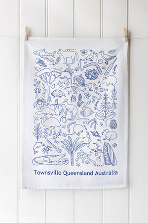 Tea towel with blue Australian animal and nature pattern on a white background