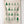 Natural tea towel with Bottle Christmas tree patterns hanging on a white wall.