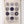 Tea towel with geometric patterns hanging on a white wooden panel