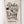 Natural cotton towel with black kitchen text hanging on a white wooden panel wall