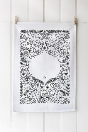 Decorative tea towel with black festive patterns on a white background