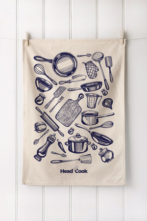 Tea towel with kitchen utensil illustrations and customers logo branding on a white wooden background
