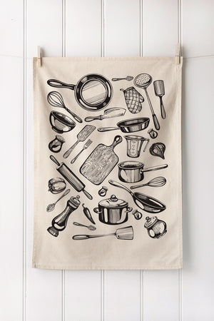 Kitchen tea towel with black illustrations of cooking utensils on a white wooden background