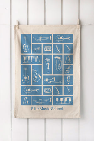 Tea towel with musical instrument illustrations and customer brand text on a white background