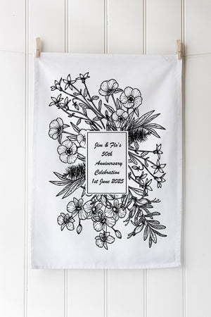 Floral design tea towel on a white background with customisable text