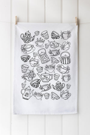 Tea towel with black line art of teapots, cups, and other tea-related items on a white background.