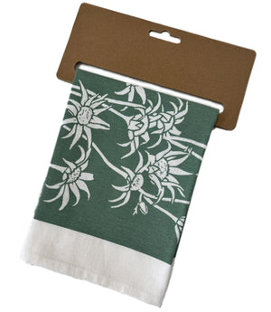 Tea towel with floral print folded neatly in kraft cardboard display hanger