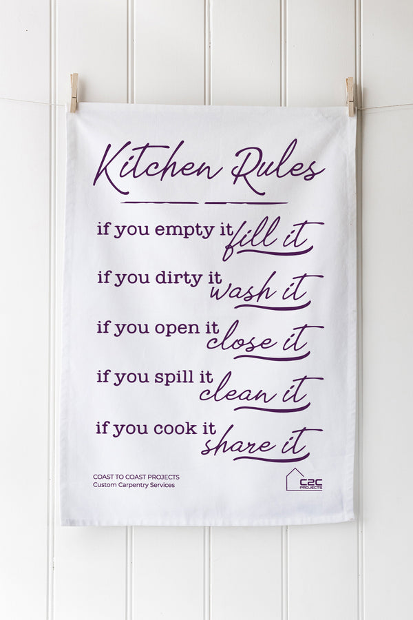 Kitchen-themed tea towel with humorous text on a white background